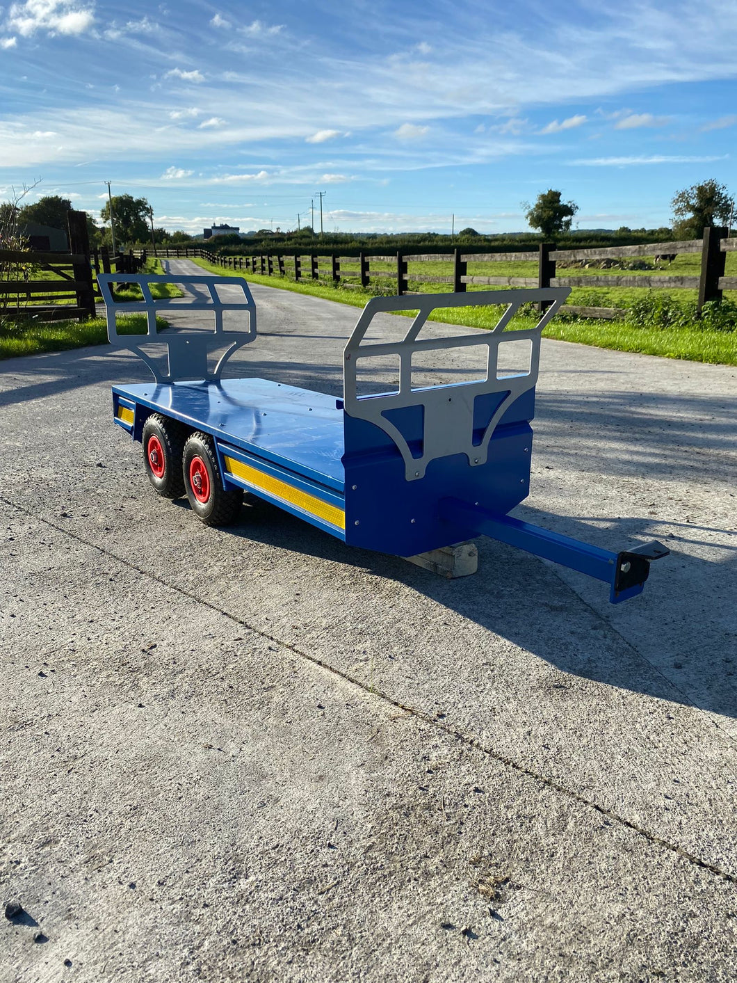 Twin axel flat trailer with bale racks